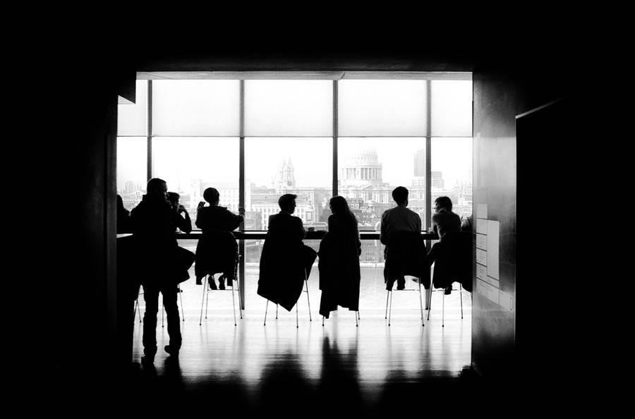 Monochrome Team Photo At Table Wallpaper