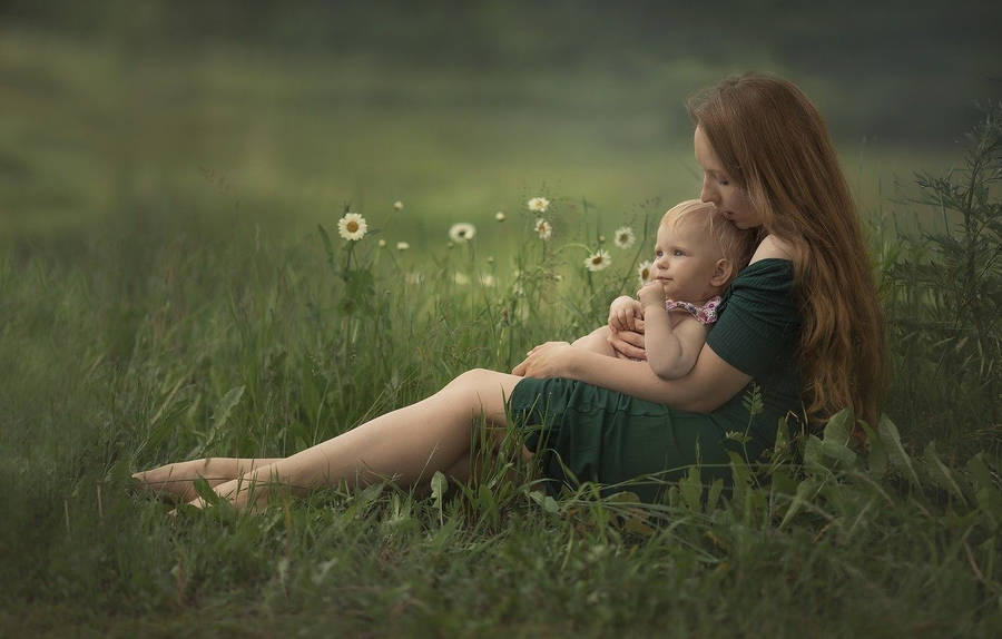 Mother And Baby On Lush Green Field Wallpaper