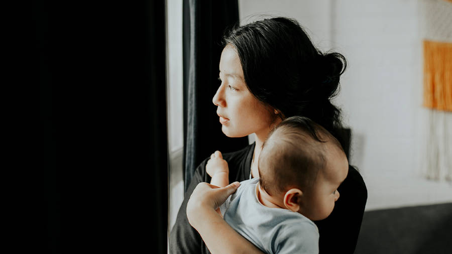 Mother Lovingly Gazing At Her Baby By The Window Wallpaper