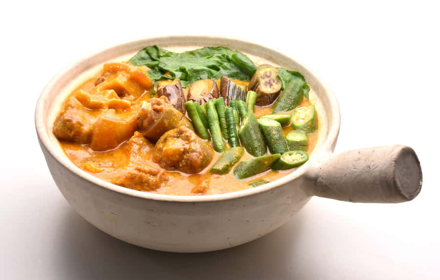Mouthwatering Kare-kare Served Hot On A Wok Wallpaper