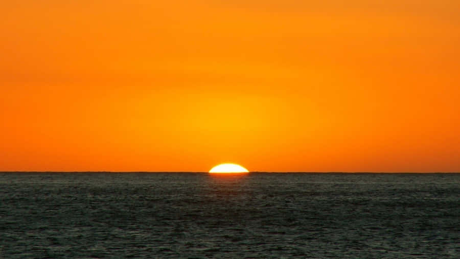 Orange Sunset And Blue Ocean Wallpaper