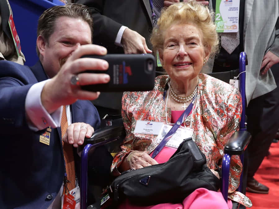 Phyllis Schlafly Posing For A Selfie With A Supporter Wallpaper