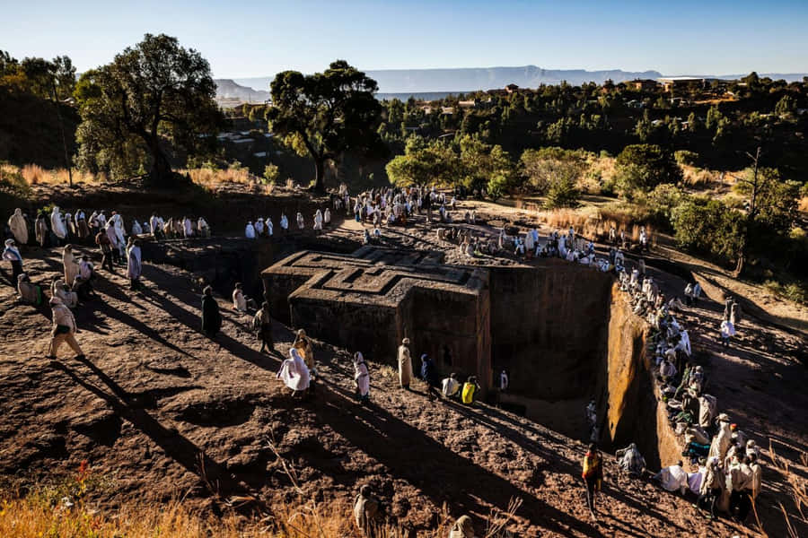 Pilgrims Around St. George Church In Lalibela Wallpaper