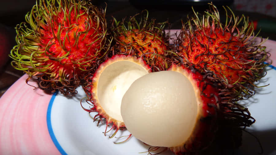 Plate Of Ripe Pulasan Fruits Wallpaper