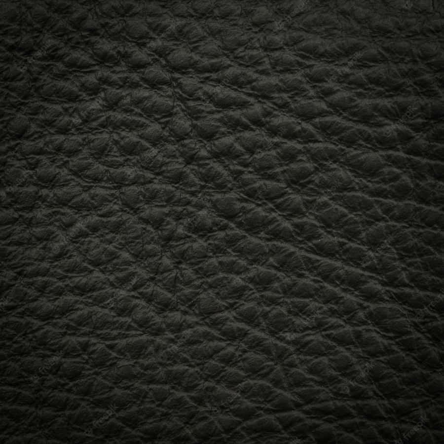 Polished Black Leather Exudes Luxury And Sophistication. Wallpaper