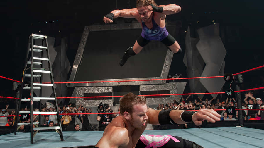 Pro Wrestlers Rob Van Dam And Christian Cage In Action Wallpaper