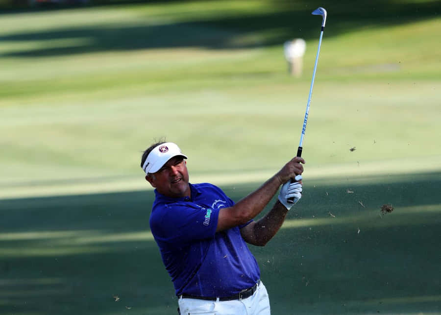 Professional Golfer Ken Duke Swings His Club On The Golf Course Wallpaper