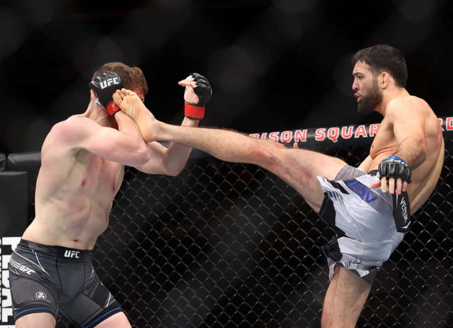 Professional Mma Fighter, Nassourdine Imavov, Skillfully Defending A Kick During A Match. Wallpaper