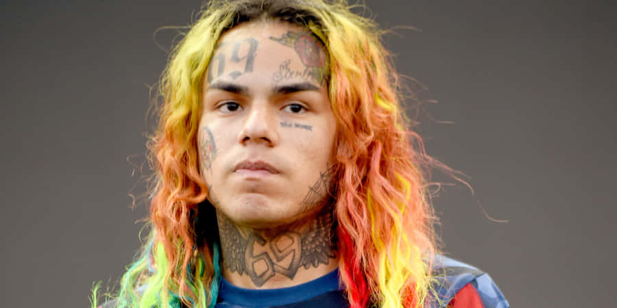 Rapper 69 Posing In Front Of A Crowd Wallpaper