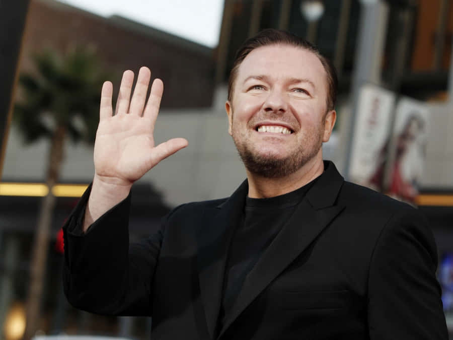 Ricky Gervais Smiling For A Photoshoot Wallpaper