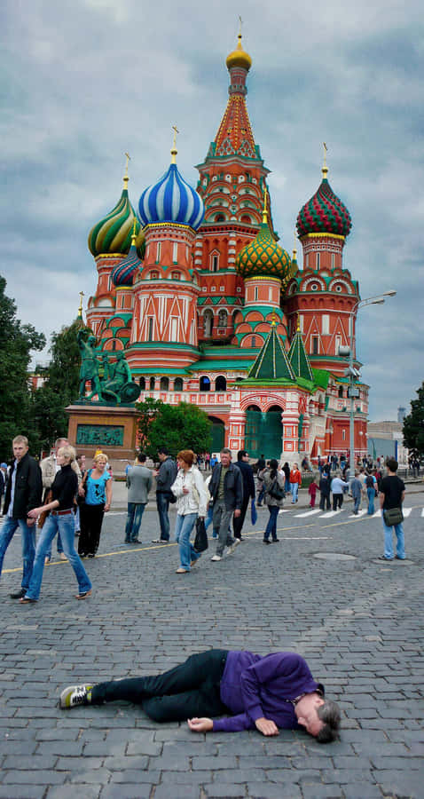 Saint Basil's Cathedral With Man Lying On The Ground Wallpaper