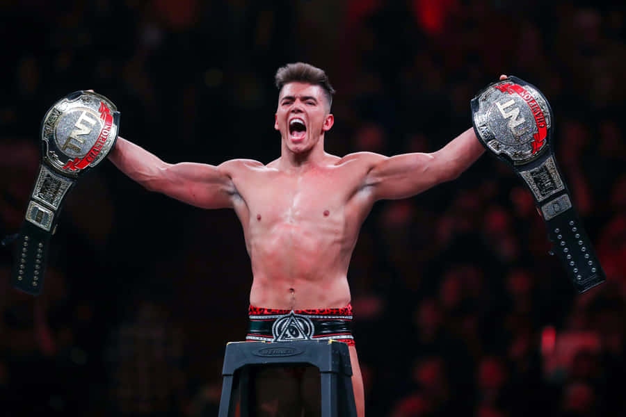 Sammy Guevara With His Championship Belts Wallpaper