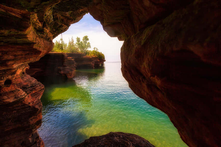 Serene_ Lake_ View_ Through_ Rock_ Arch Wallpaper