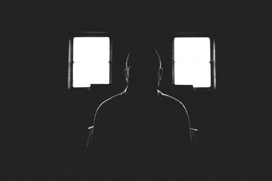 Silhouette Of A Person In Shadowed Room Wallpaper