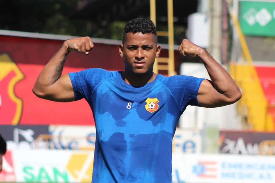 Soccer Player Flexing Muscleson Field Wallpaper