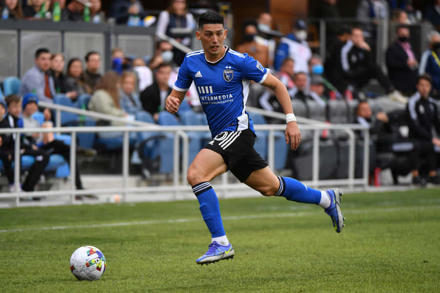 Soccer_ Player_in_ Action_on_ Field.jpg Wallpaper