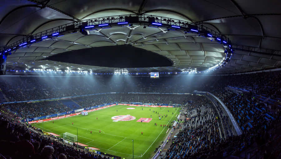 Spectators Enter The Soccer Stadium To Take Part In The Action Wallpaper