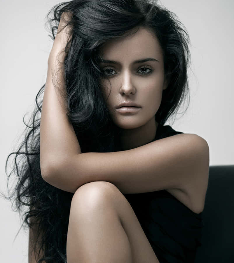 Striking Young Female Model With Curly Black Hair Wallpaper