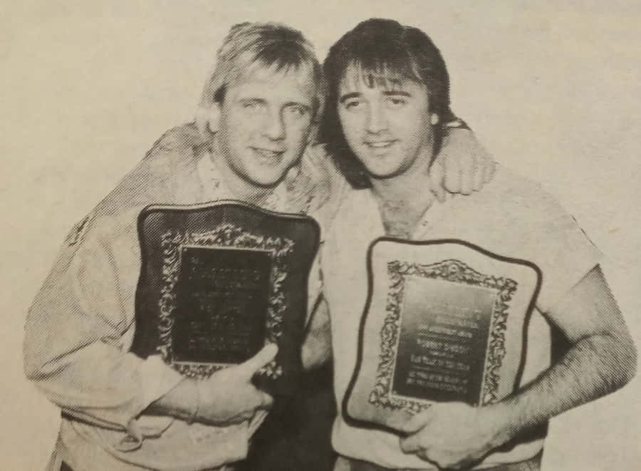 Tag Team Champions Holding Plaques Wallpaper