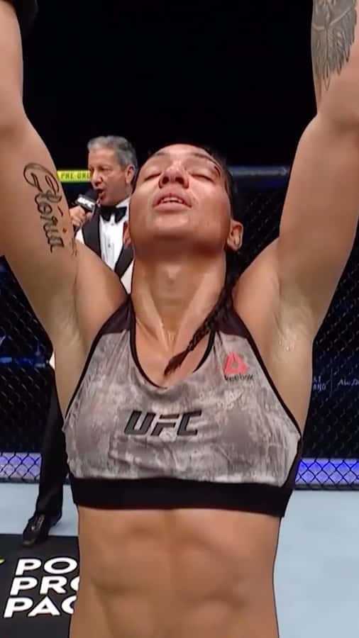 Taila Santos Celebrating Victory With Arms Up Wallpaper