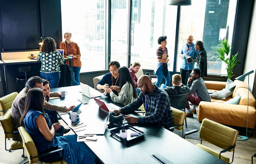 Team Working Together In Office Wallpaper