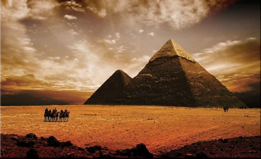 The Majestic Giza Pyramids Under Sunny Egyptian Skies Wallpaper