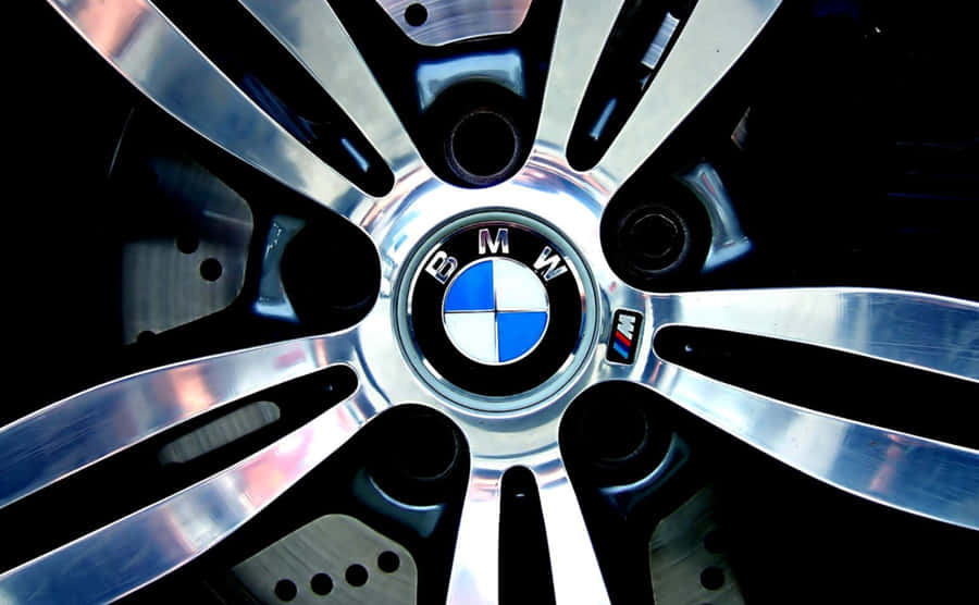 The Official Bmw Logo Against A Blue Background Wallpaper