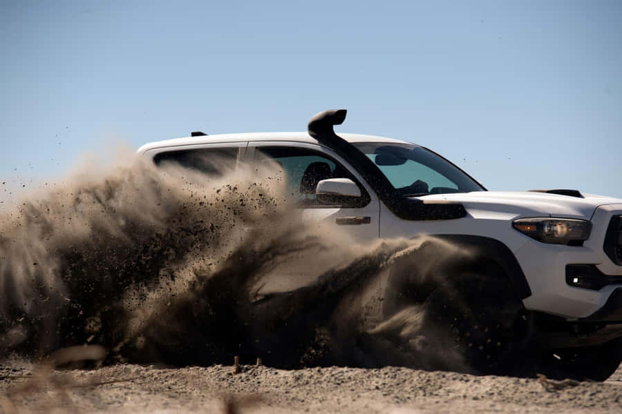 Toyota Trd Driving Through Dust Wallpaper