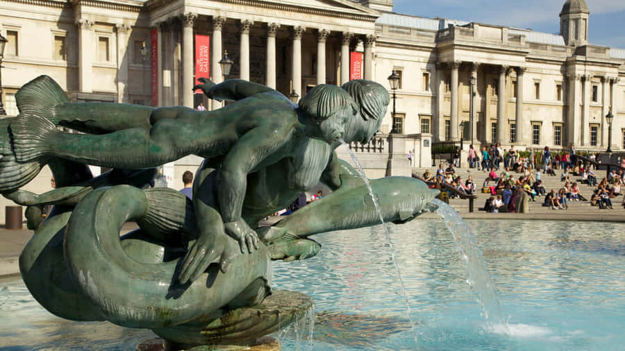 Trafalgar Square Fountain Featuring Dolphins And Mermaids Sculpture Wallpaper