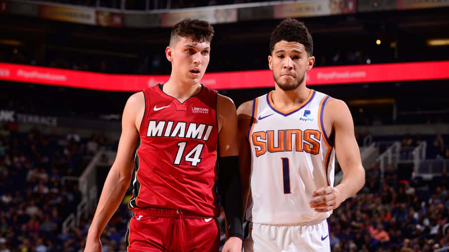 Tyler Herro Takes A Jump Shot During An Basketball Game Wallpaper