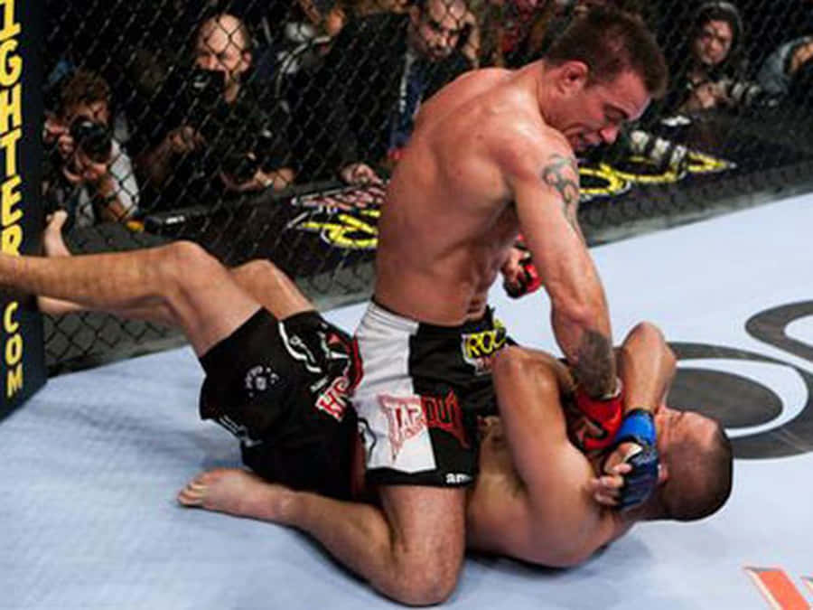 Ufc Athletes Jake Shields And Georges St-pierre In The Ring At Ufc 129 Wallpaper