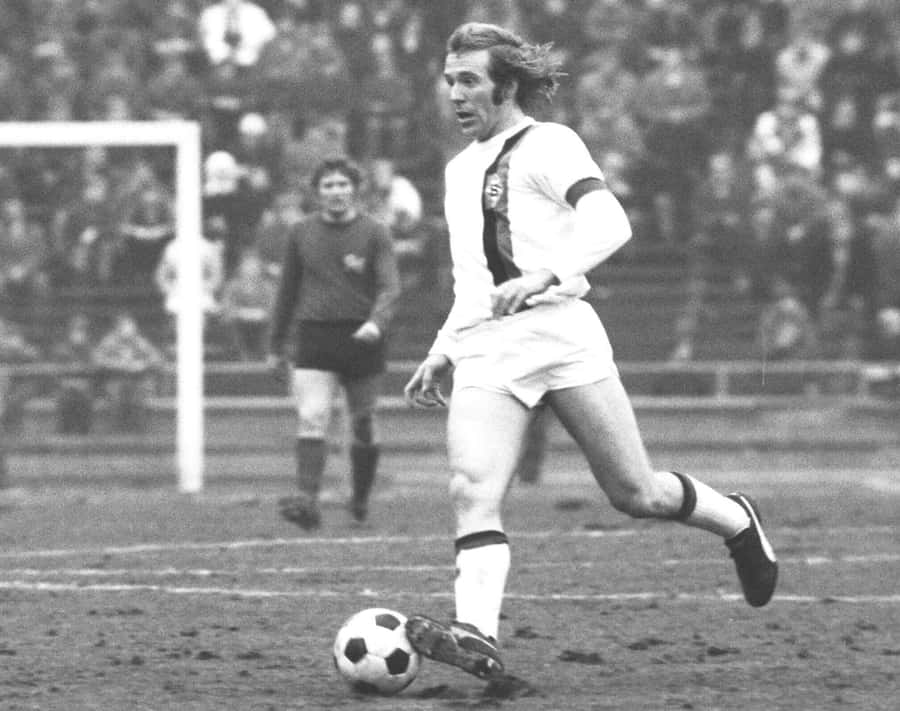 Vintage Soccer Player Action Shot Wallpaper