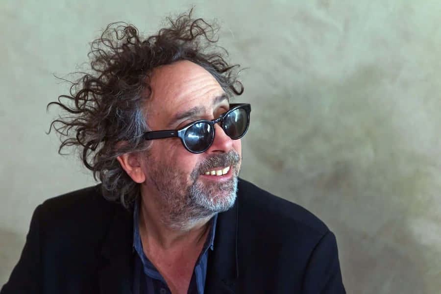 Visionary Tim Burton Immersed In His Eccentric Cinematic World Wallpaper