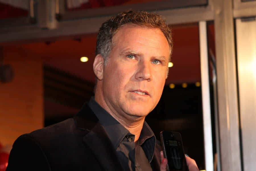 Will Ferrell Striking A Confident Pose On A Rooftop Wallpaper