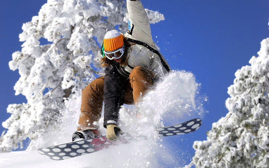 Woman With An Orange Beanie And Snowboard Wallpaper