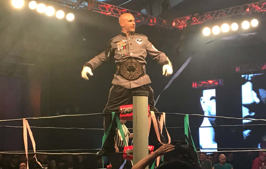 Wrestler With Championship Belt In Ring Wallpaper