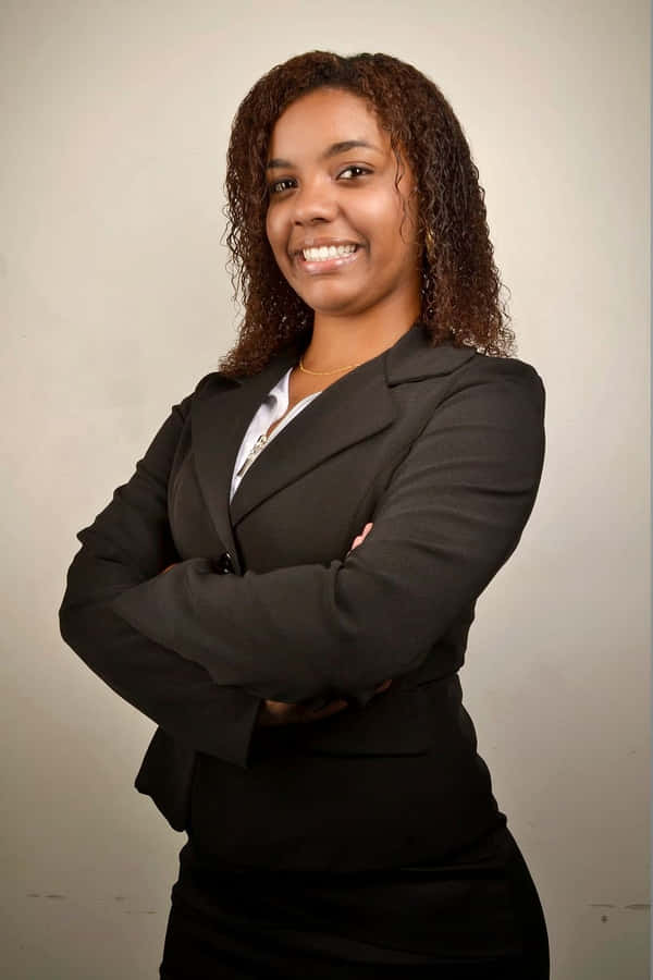 Young Professional Black Woman Dressed In Business Attire Wallpaper