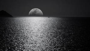 2560 X 1440 Large Moon At Sea Wallpaper