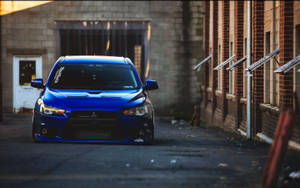 4k Jdm Mitsubishi Outside Brick Buildings Wallpaper