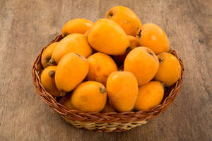 A Basket Full Of Fresh Loquat Oranges Wallpaper