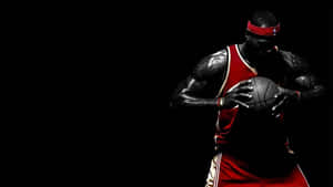 A Basketball Player Holding A Ball In His Hands Wallpaper