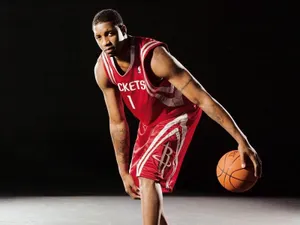 A Basketball Player In Red Uniform Posing For A Photo Wallpaper