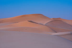 A Beautiful Desert Scene With Blue Sky Wallpaper