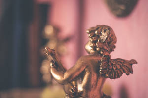 A Beautiful Gold Figurine Wallpaper