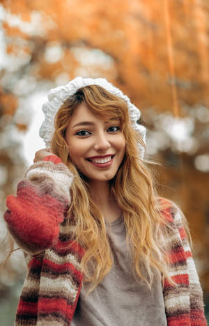 A Beautiful Young Girl Embracing The Autumn Season. Wallpaper