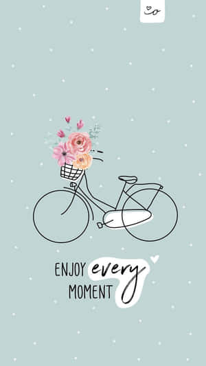 A Bicycle With Flowers In A Basket And The Words Enjoy Every Moment Wallpaper