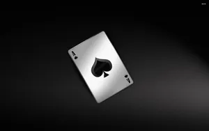 A Black And Silver Playing Card On A Black Background Wallpaper