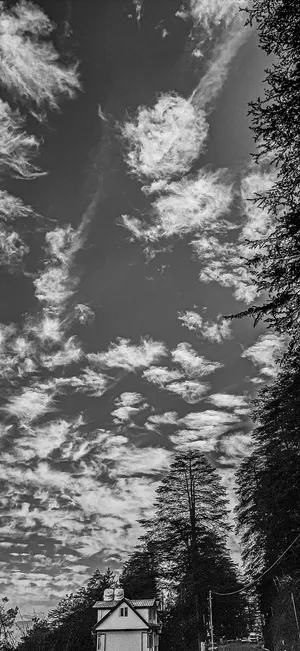 A Black And White Photo Of A House In The Sky Wallpaper