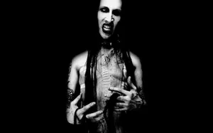 A Black And White Photo Of A Man With Dreadlocks Wallpaper