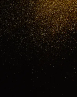 A Black Background With Gold Glitter Wallpaper
